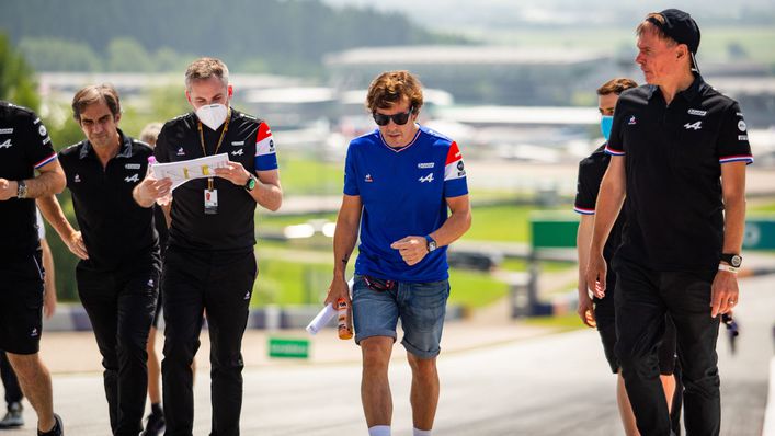 Fernando Alonso, in blue, on a track walk with his Alpine crew at the Red Bull Ring