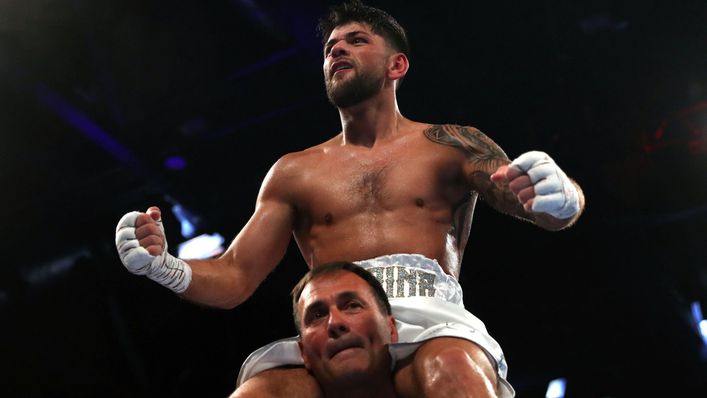 Trainer Tony Sims gives Joe Cordina a lift as he celebrates