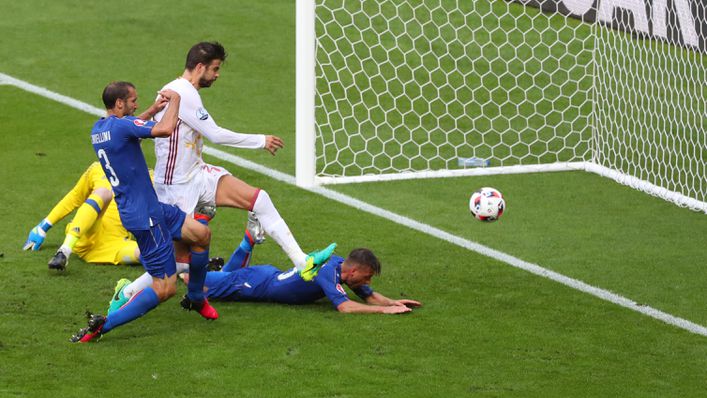 Giorgio Chiellini scrambles the ball home for Italy's opener