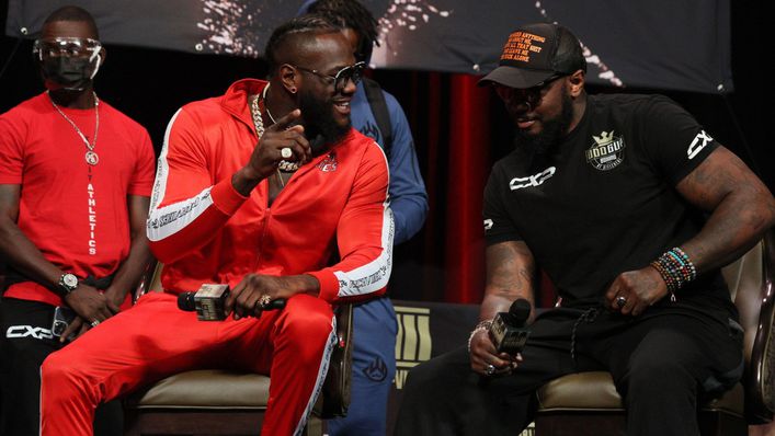 Deontay Wilder in discussion with trainer Malik Scott during the final press conference