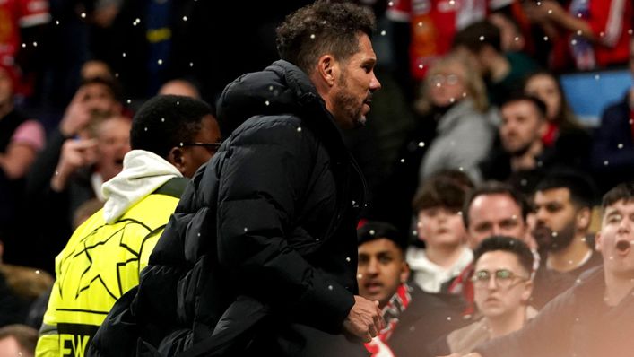 Liquid lands on Diego Simeone as objects are thrown at him at the full-time whistle