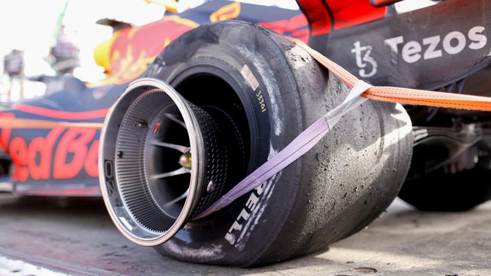 Max Verstappen's Red Bull is carted away in Baku after a rear-tyre blowout