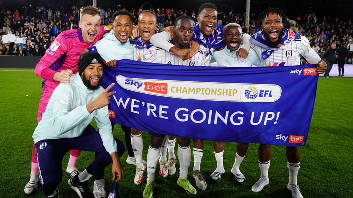 Fulham stars celebrate the club's promotion with a 'We're going up' banner