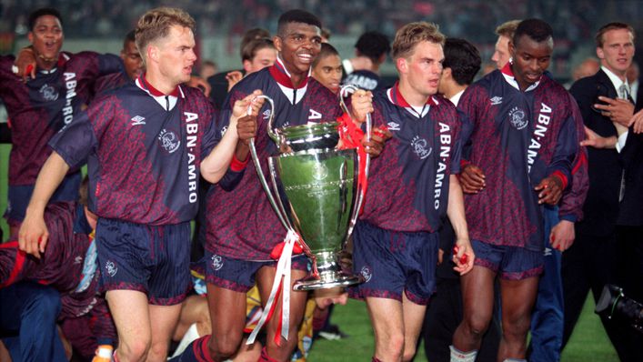 The De Boer brothers hold the trophy aloft with Nwankwo Kanu to start the Ajax celebrations in 1995
