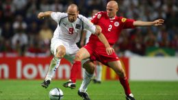 Jan Koller and Denmark's Kasper Bogelund battle for the ball at Euro 2004